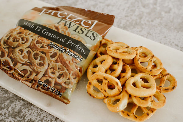Dig into naturally flavoured pretzel twists with 12g of protein. Savoury protein snacks available at High Peak Nutrition Canada.